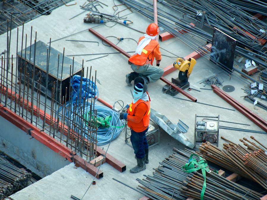 Construction workers on a site with steel reinforcement bars