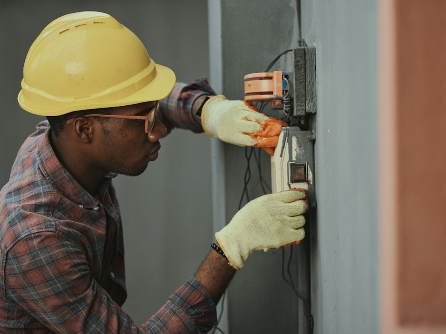 Technician wearing a safety helmet and protective gloves