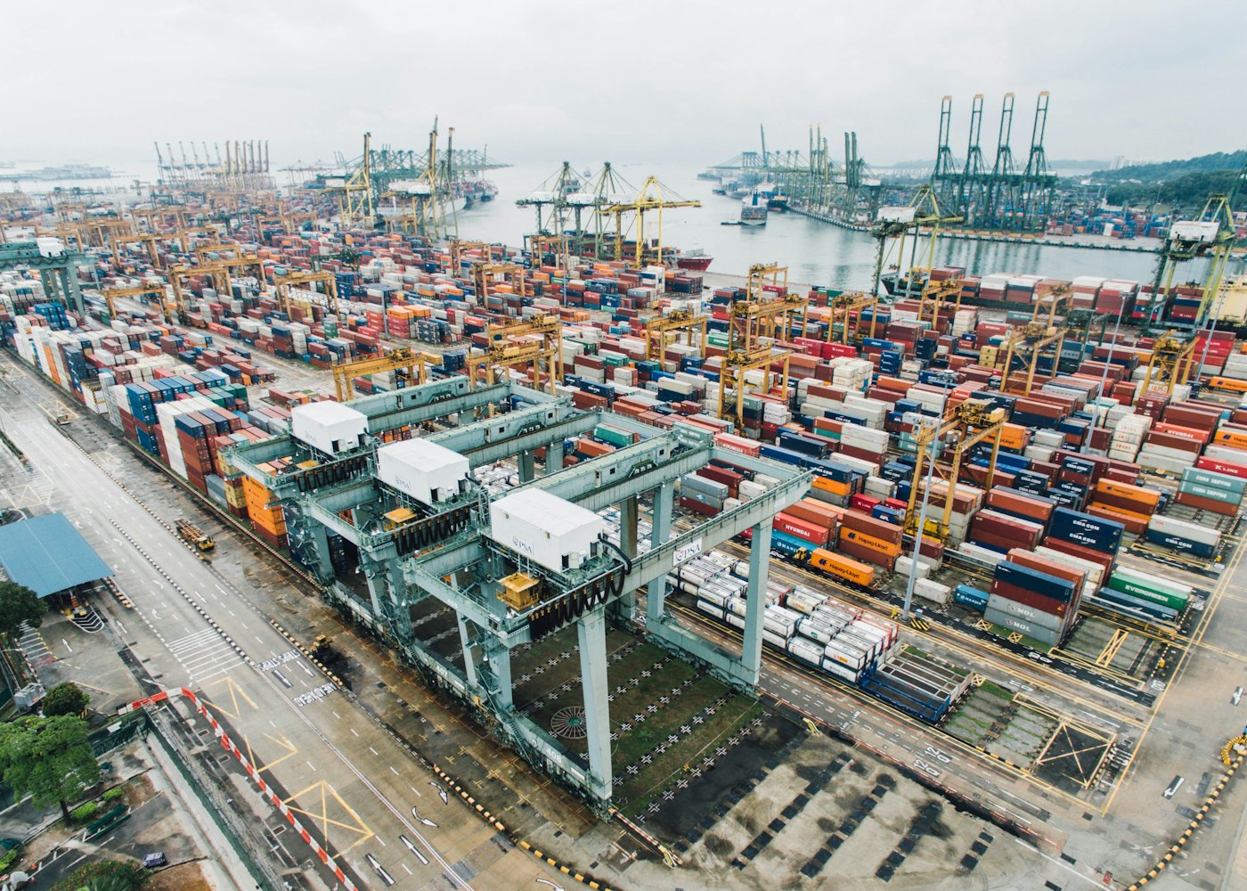 Aerial view of a busy container port with shipping cranes